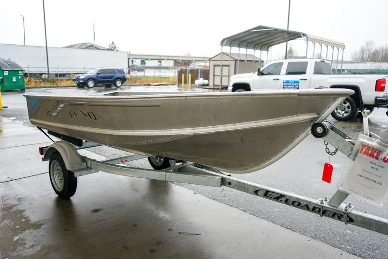 Slide: The Image of 2021 Lund WC-12 boat on EZ Loader trailer in parking lot. - 11