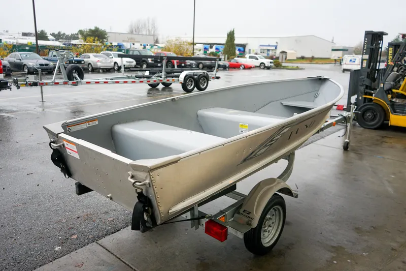 Slide: The Image of 2021 Lund WC-12 aluminum boat on trailer in parking lot. - 13