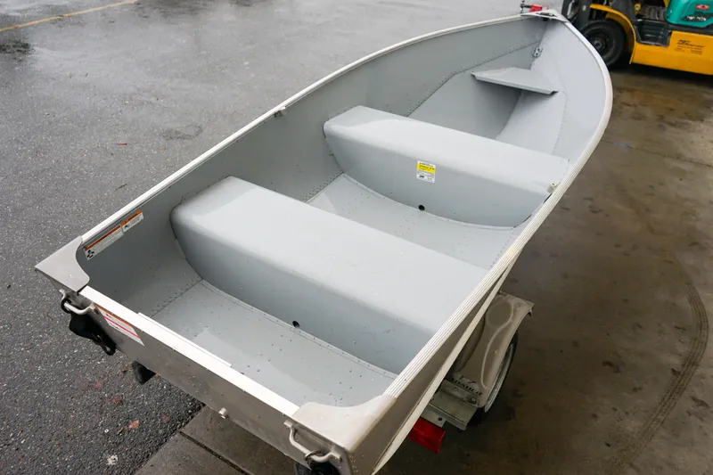 Slide: The Image of 2021 Lund WC-12 aluminum boat on trailer, parked on wet pavement. - 14