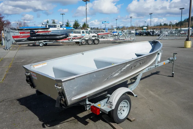 Slide: The Image of 2021 Lund WC-12 aluminum boat on trailer in outdoor dealership lot. - 9