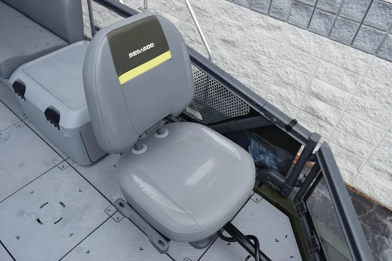 Slide: The Image of 2025 Sea-Doo Switch Fish 18 boat seat with storage compartment, gray upholstery. - 11