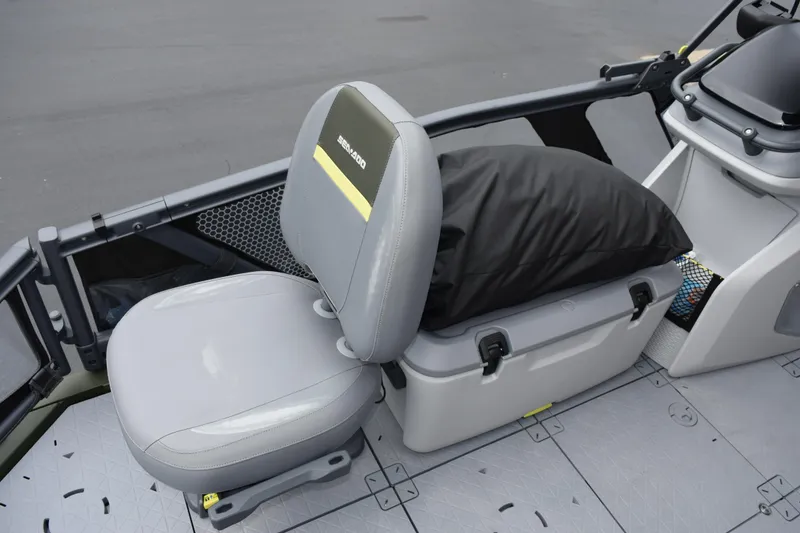 Slide: The Image of 2025 Sea-Doo Switch Fish 18 interior seating with storage compartment and cushion. - 12