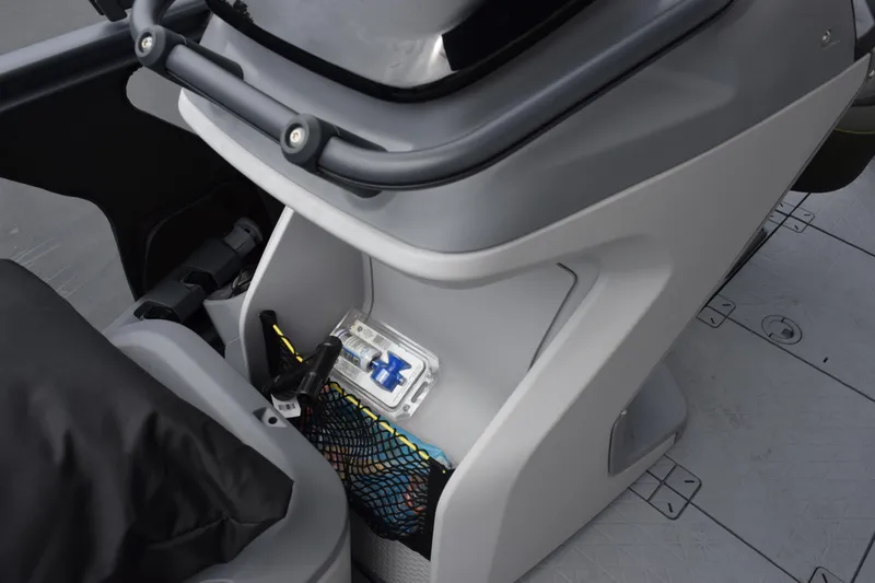 Slide: The Image of 2025 Sea-Doo Switch Fish 18 interior storage compartment with safety equipment and accessories. - 18