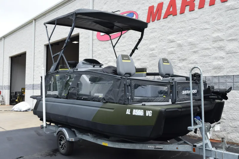 Slide: The Image of 2025 Sea-Doo Switch Fish 18 on trailer outside marine dealership. - 2