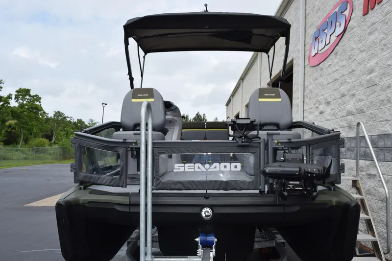 Slide: The Image of 2025 Sea-Doo Switch Fish 18 pontoon boat parked outside dealership. - 3