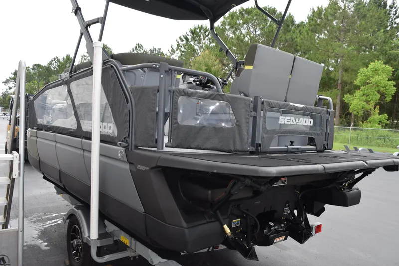 Slide: The Image of 2025 Sea-Doo Switch Fish 18 pontoon boat on trailer, rear view, outdoors. - 7