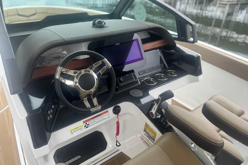Slide: The Image of Cockpit of 2026 Monterey Elite 25 SD boat with modern steering and controls. - 3