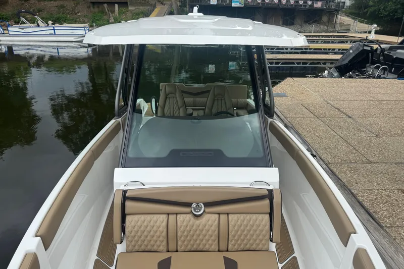 Slide: The Image of 2026 Monterey Elite 25 SD boat docked, featuring sleek design and luxurious seating. - 9
