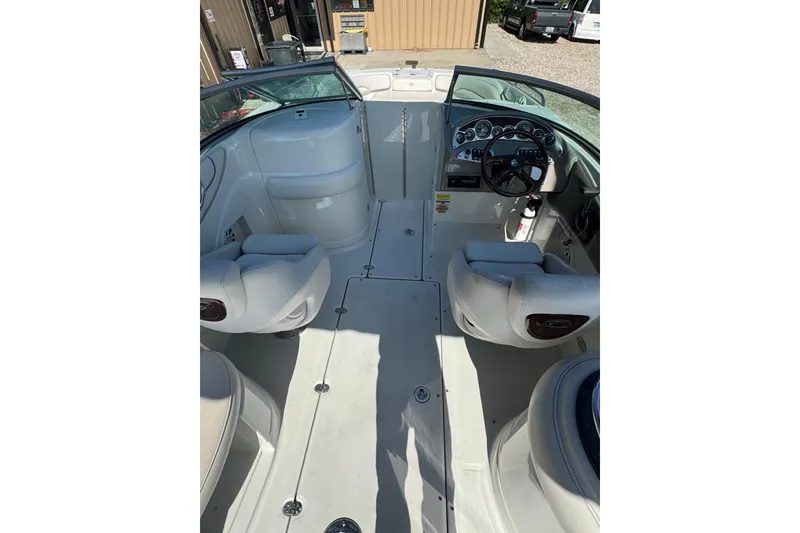 Slide: The Image of 2005 Crownline 240 EX boat interior with seating and dashboard view. - 11