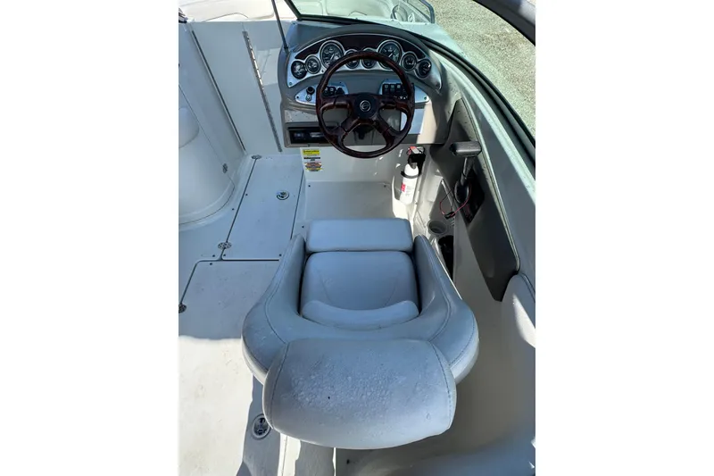 Slide: The Image of 2005 Crownline 240 EX boat cockpit with steering wheel and dashboard controls. - 12