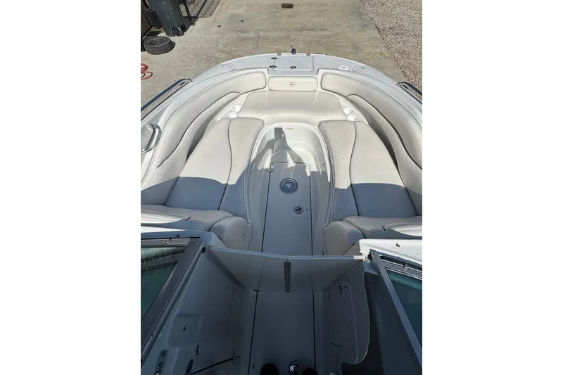 Slide: The Image of 2005 Crownline 240 EX boat interior with white seating and open deck layout. - 13