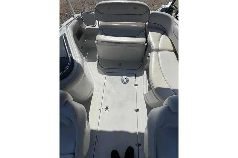 Slide: The Image of 2005 Crownline 240 EX boat interior with white seating and spacious layout. - 16