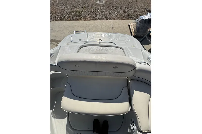 Slide: The Image of 2005 Crownline 240 EX boat interior with white seating and deck view. - 17