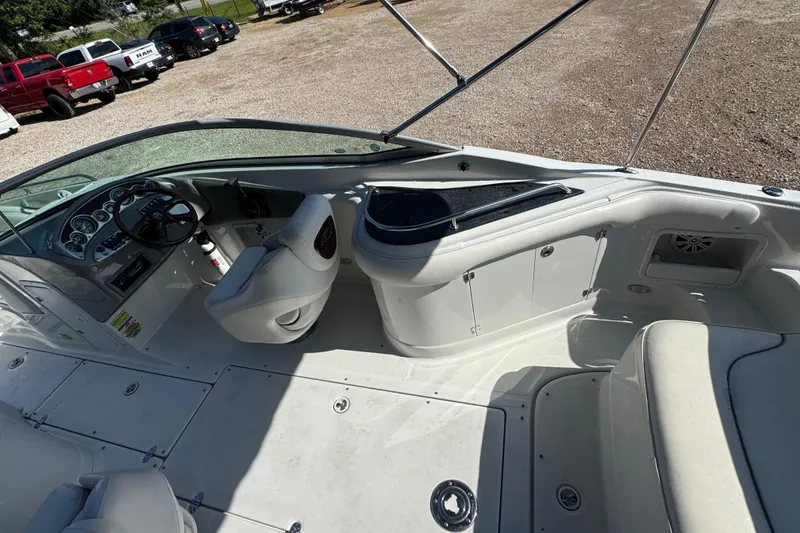 Slide: The Image of 2005 Crownline 240 EX boat interior with steering wheel and seating area. - 18