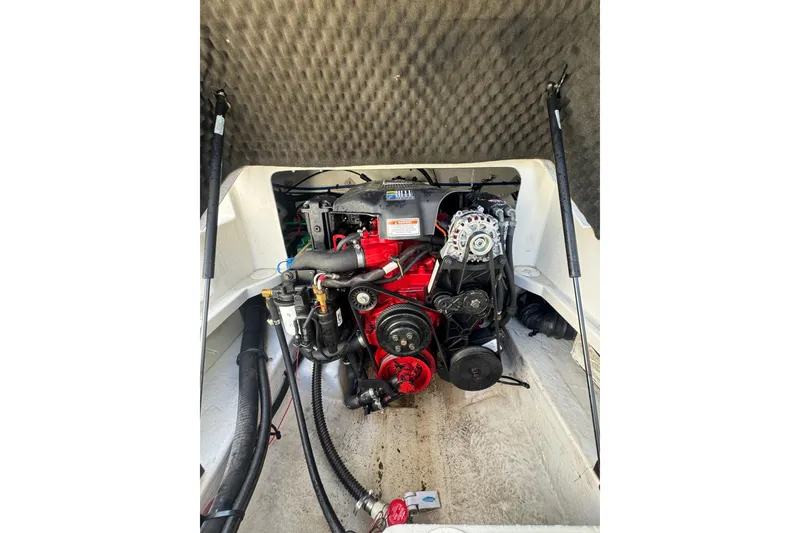 Slide: The Image of Engine compartment of a 2005 Crownline 240 EX boat, showcasing detailed mechanics. - 20