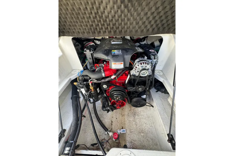 Slide: The Image of Engine compartment of a 2005 Crownline 240 EX boat, showcasing detailed mechanical components. - 21