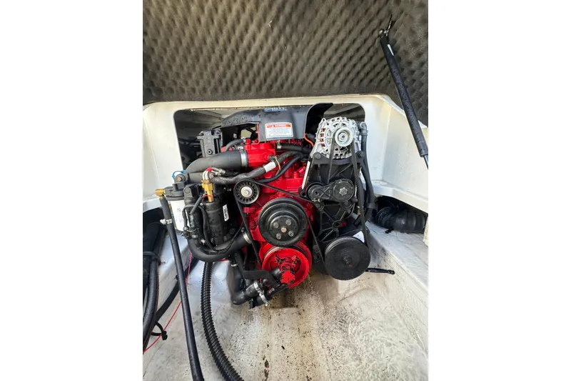 Slide: The Image of Engine compartment of a 2005 Crownline 240 EX boat, showcasing mechanical components. - 22