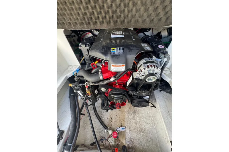 Slide: The Image of Engine compartment of a 2005 Crownline 240 EX boat, showcasing detailed mechanical components. - 23