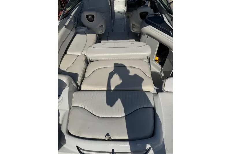 Slide: The Image of Interior of 2005 Crownline 240 EX boat with white seating and shadow. - 24