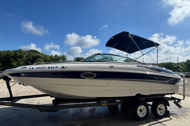 Slide: The Image of 2005 Crownline 240 EX boat on trailer under blue sky. - 5
