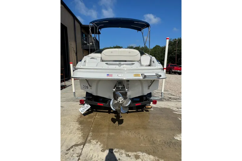 Slide: The Image of Rear view of a 2005 Crownline 240 EX boat with blue canopy. - 8