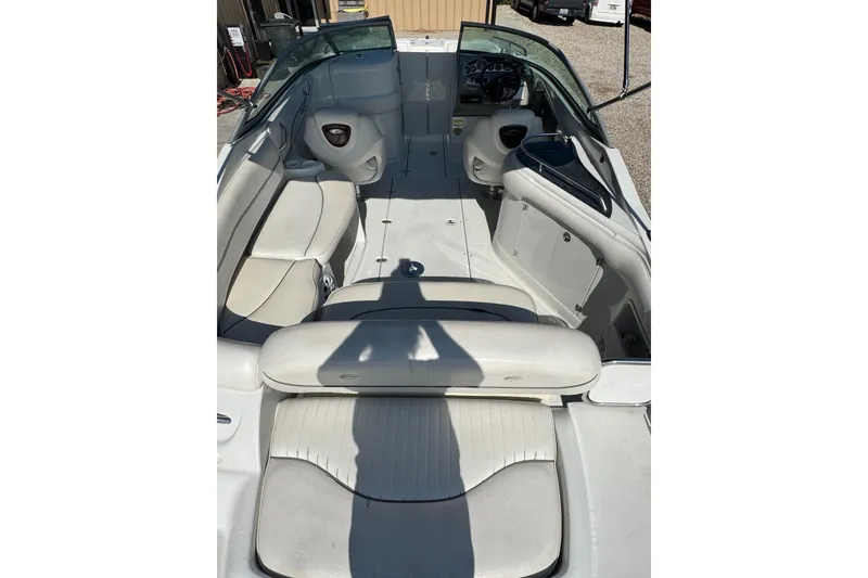 Slide: The Image of 2005 Crownline 240 EX boat interior with white seating and steering console. - 9