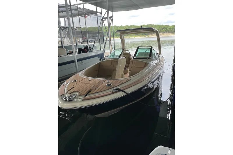 Slide: The Image of 2022 Chris Craft 28 Launch boat docked, featuring sleek design and luxurious interior. - 0