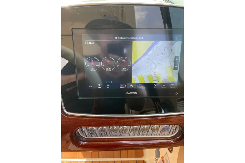 Slide: The Image of Garmin display on 2022 Chris Craft 28 Launch boat dashboard, showing navigation and gauges. - 1