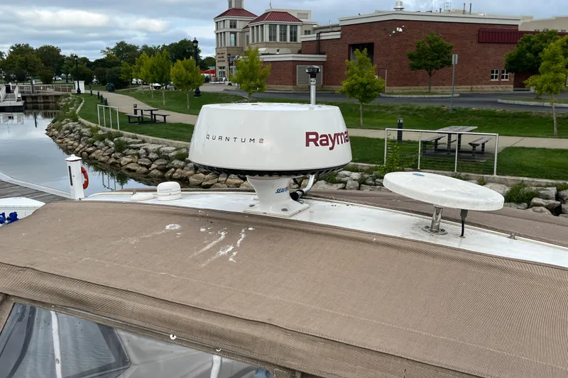 Slide: The Image of 2005 Chaparral Signature 350 boat with Raymarine Quantum 2 radar docked near a park. - 14