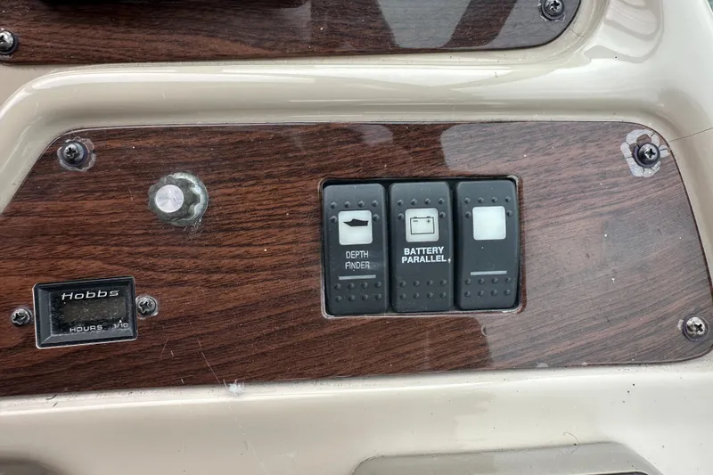 Slide: The Image of Control panel of a 2005 Chaparral Signature 350 boat with switches and hour meter. - 21