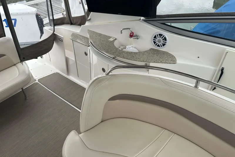 Slide: The Image of Interior of a 2005 Chaparral Signature 350 boat with seating and kitchenette area. - 25