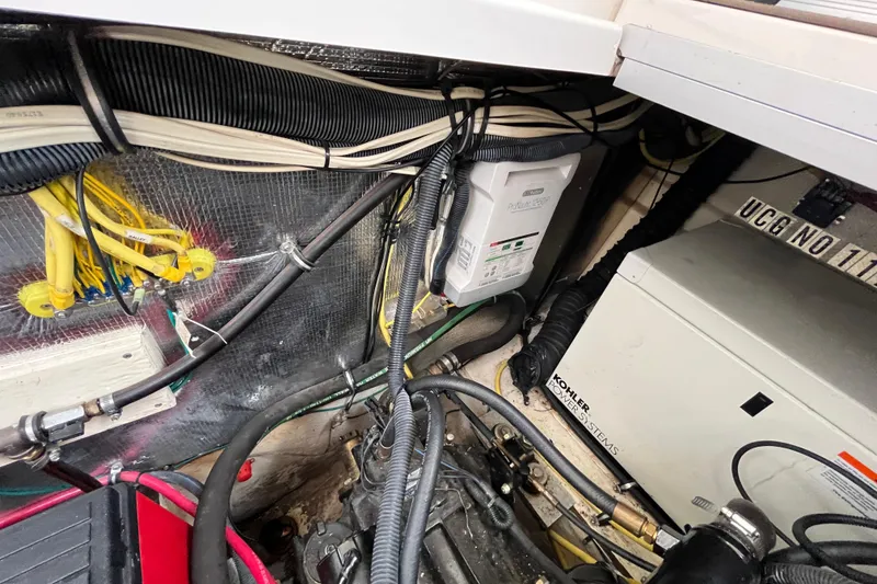 Slide: The Image of Engine compartment of a 2005 Chaparral Signature 350 boat with wiring and equipment. - 36