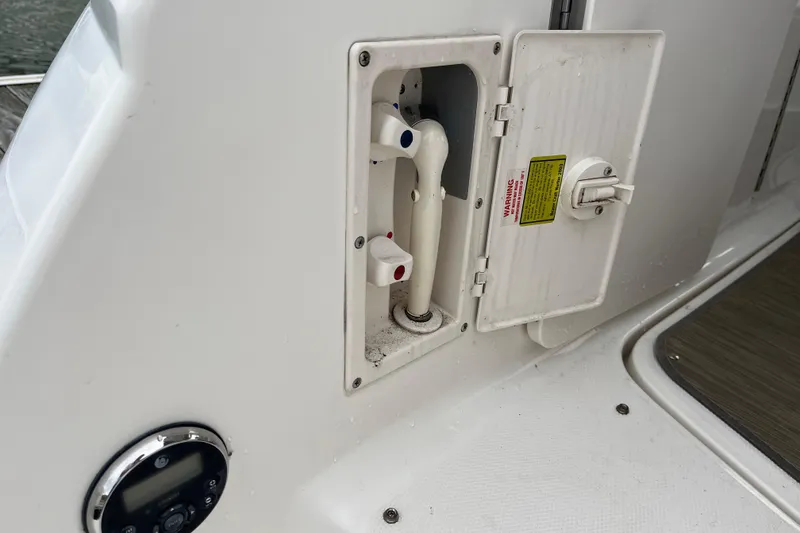 Slide: The Image of 2005 Chaparral Signature 350 boat shower compartment with open hatch and control knobs. - 38