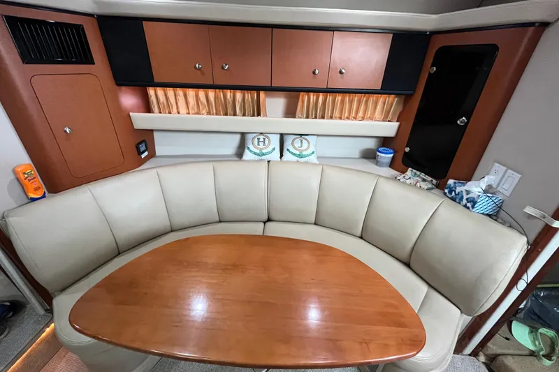 Slide: The Image of 2005 Chaparral Signature 350 interior with curved seating and wooden table. - 40