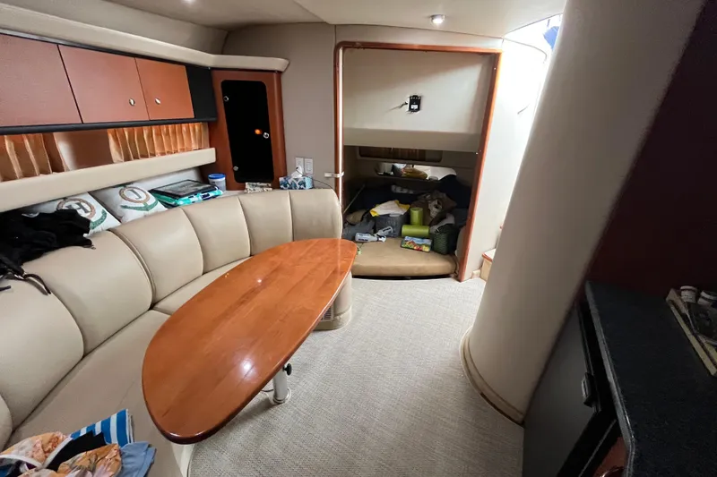 Slide: The Image of Interior of 2005 Chaparral Signature 350 yacht with beige seating and wooden table. - 42