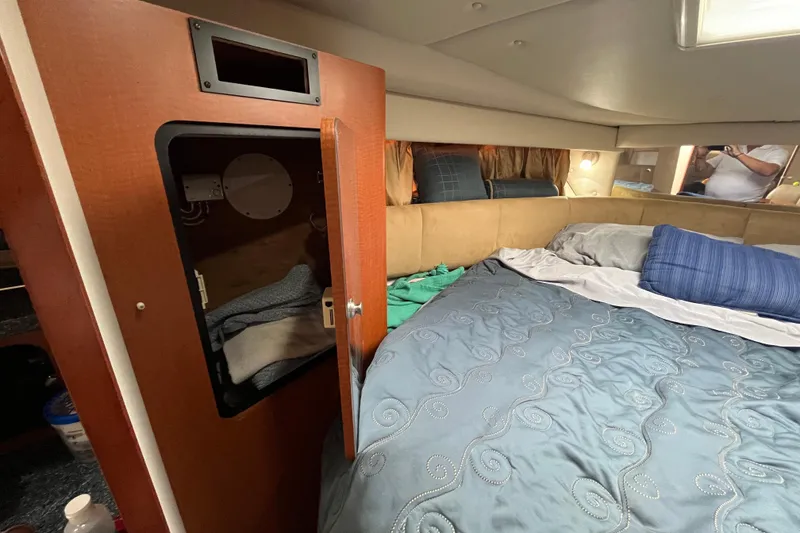 Slide: The Image of Interior cabin of 2005 Chaparral Signature 350 with bed and open closet. - 45