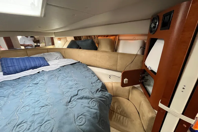 Slide: The Image of 2005 Chaparral Signature 350 cabin interior with bed, pillows, and storage compartment. - 46