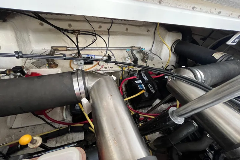 Slide: The Image of Engine compartment of a 2005 Chaparral Signature 350 boat, showing cables and components. - 54