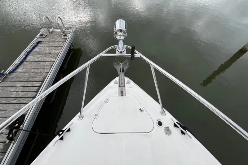Slide: The Image of Bow view of 2005 Chaparral Signature 350 yacht docked by a wooden pier. - 8
