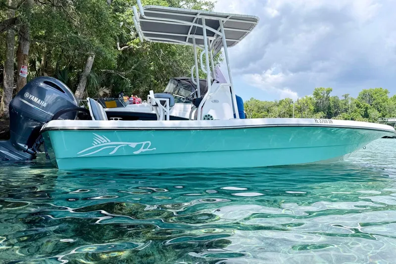 The Image of 2019 Epic 21 Bay boat with Yamaha engine on clear water, surrounded by trees. - 1