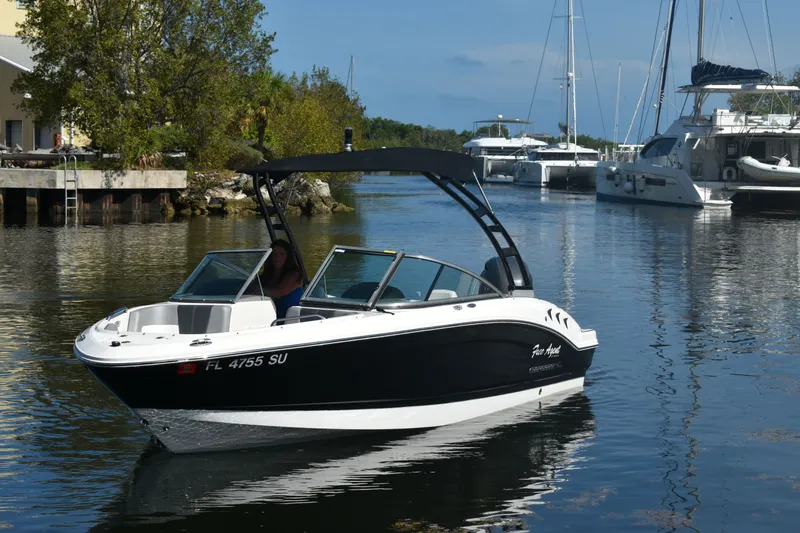 The Image of 2021 Chaparral 21 SSi boat on calm water in harbor. - 0