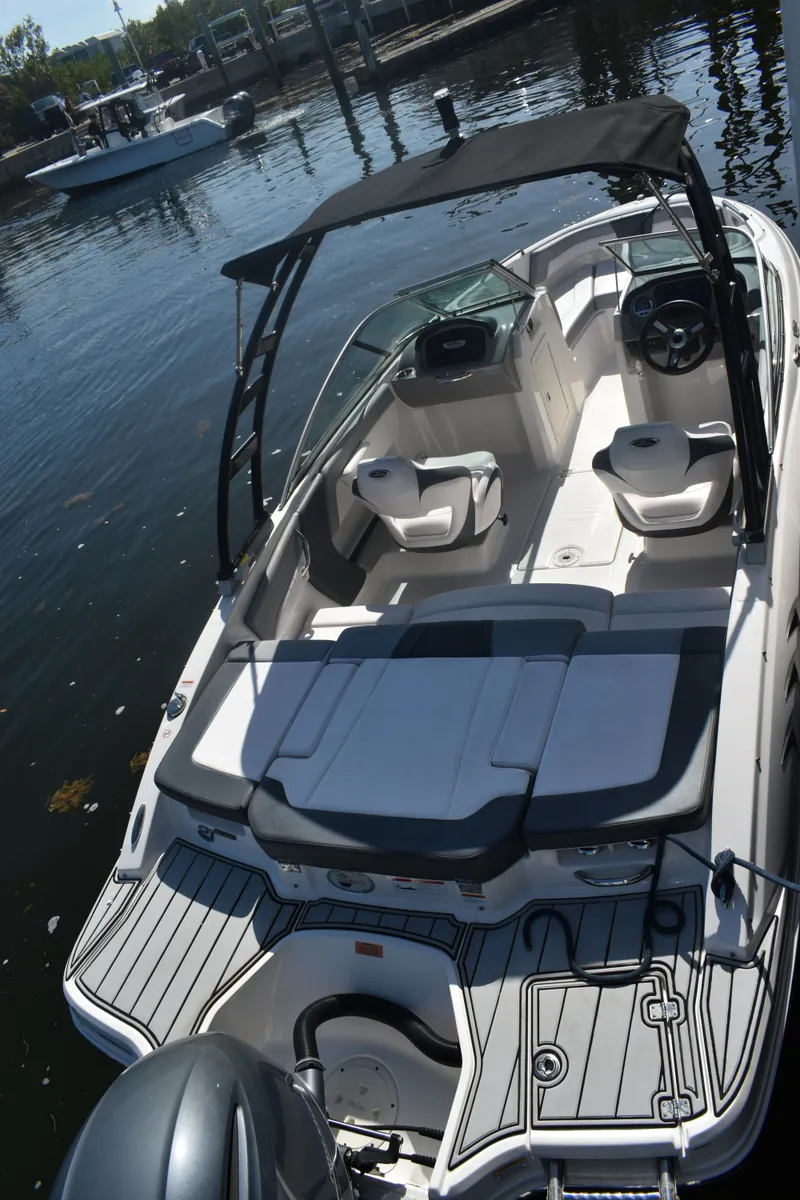 Slide: The Image of 2021 Chaparral 21 SSi boat docked with open deck view. - 12