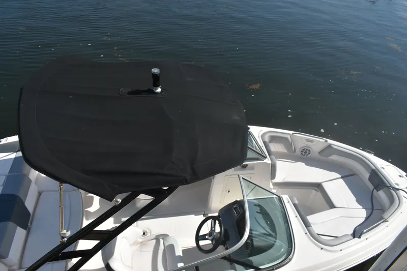Slide: The Image of 2021 Chaparral 21 SSi boat with black sunshade on water. - 13