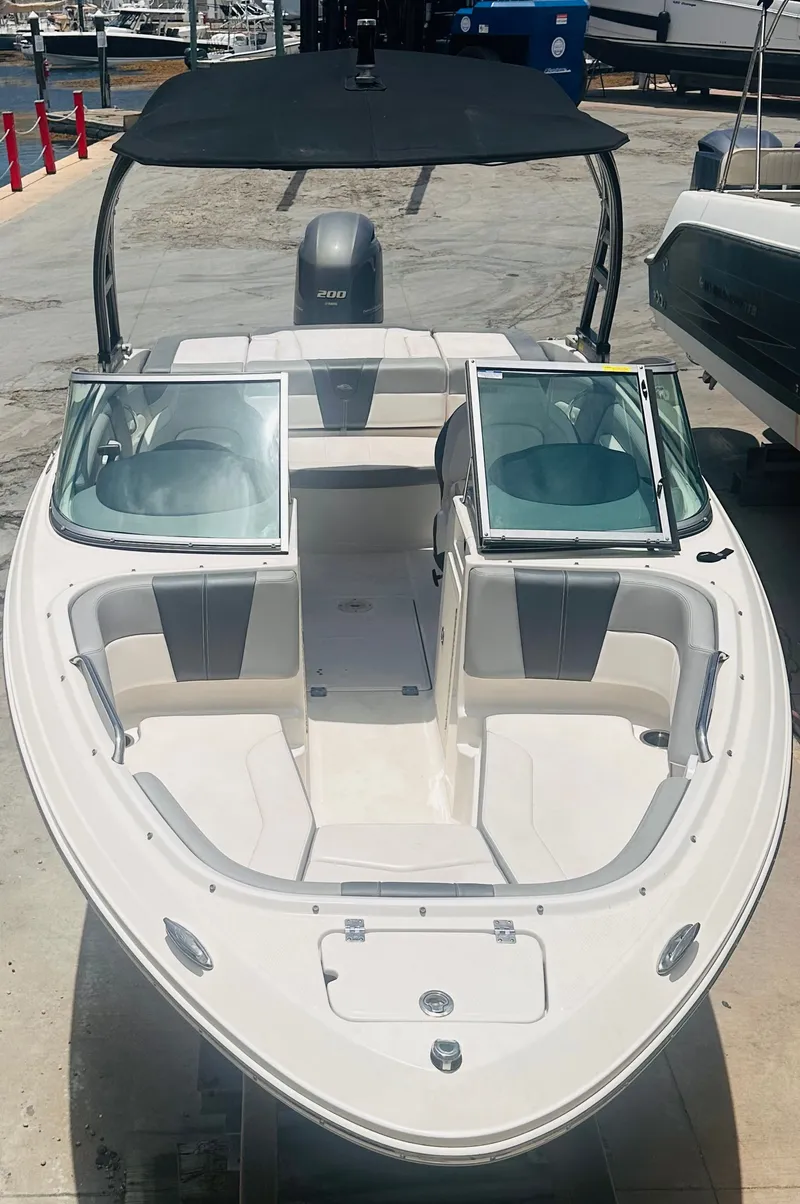 Slide: The Image of 2021 Chaparral 21 SSi boat with open cockpit and black canopy. - 16