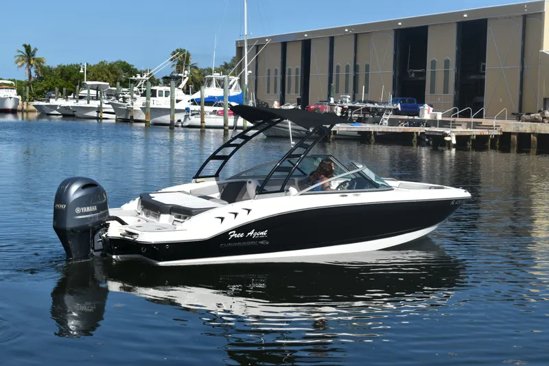 Slide: The Image of 2021 Chaparral 21 SSi boat on water with Yamaha engine. - 2