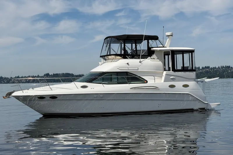 The Image of 1997 Sea Ray 370 Aft Cabin yacht on calm water under a blue sky. - 0