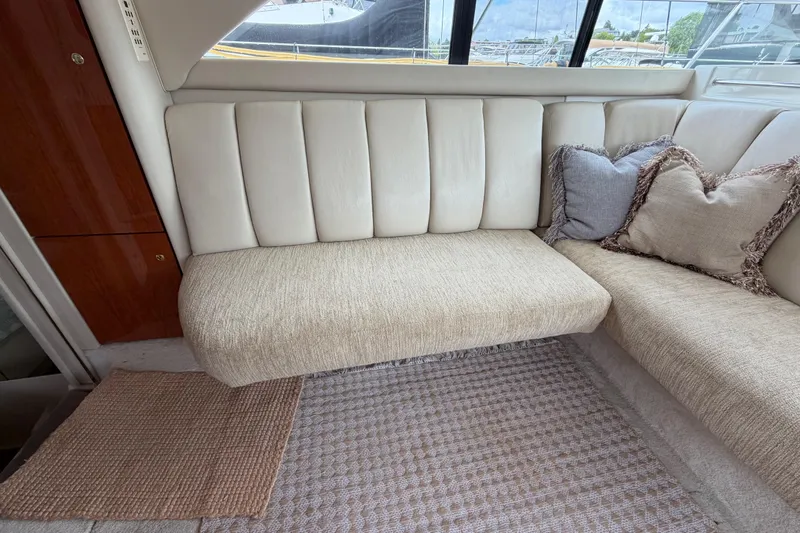 Slide: The Image of Interior seating area of a 1997 Sea Ray 370 Aft Cabin yacht with cushions and carpet. - 19