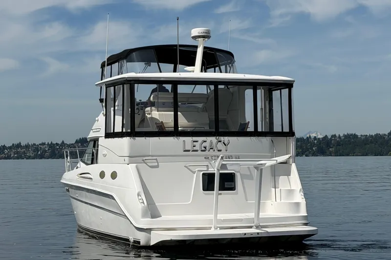 Slide: The Image of 1997 Sea Ray 370 Aft Cabin boat on calm water, rear view. - 2