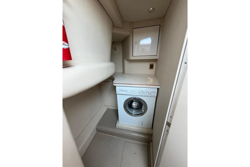Slide: The Image of Laundry area in 1997 Sea Ray 370 Aft Cabin yacht with washer and storage cabinet. - 24