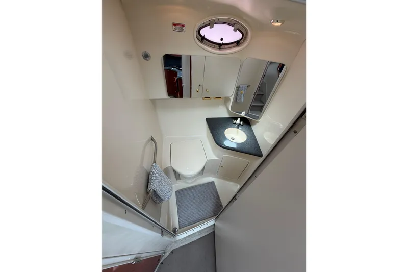 Slide: The Image of Bathroom interior of 1997 Sea Ray 370 Aft Cabin yacht, featuring sink and toilet. - 28
